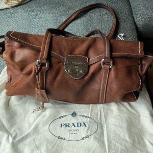 Beautiful genuine leather Prada bag with a lock and key.